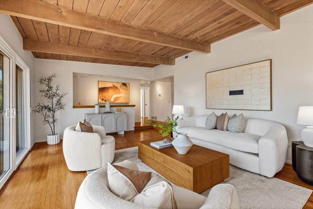 Living room under a beamed wood-plank ceiling