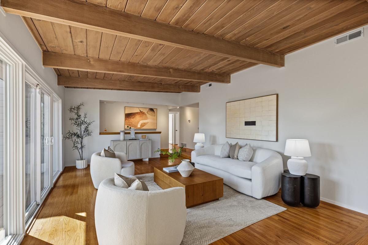 Hardwood floor running through the living room toward the sliding doors