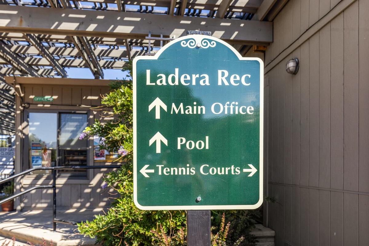 Ladera Rec sign pointing to the main office, pool and tennis courts